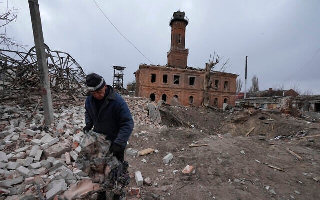 A man holds fragments of a rocket launched by the Russian forces at night, a rocket crater behind him, in the center of Kharkiv, Ukraine, March 27, 2022. (AP Photo/Efrem Lukatsky) A man holds fragments of a rocket launched by the Russian forces at night, a rocket crater behind him, in the center of Kharkiv, Ukraine, March 27, 2022. (AP Photo/Efrem Lukatsky)