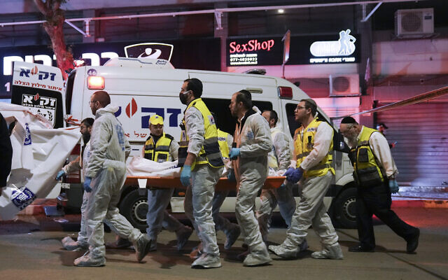 Israeli Zaka Rescue and Recovery team carry the body of a victim at the scene of shooting attack In Hadera, March 27, 2022. (AP Photo/Ariel Schalit) Israeli Zaka Rescue and Recovery team carry the body of a victim at the scene of shooting attack In Hadera, March 27, 2022. (AP Photo/Ariel Schalit)