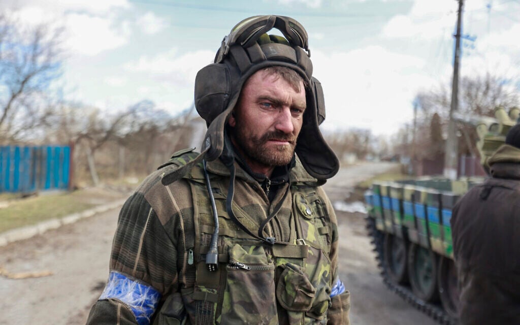 A Ukrainian serviceman stands in a street in Lukyanivka, Kyiv region, Ukraine, March 27, 2022. (AP Photo)