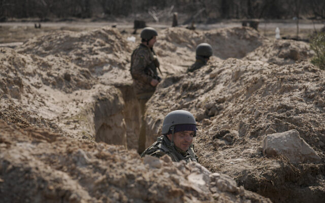 Ukrainian servicemen stand in trenches at a position north of the capital Kyiv, Ukraine, Tuesday, March 29, 2022. (AP/Vadim Ghirda) Ukrainian servicemen stand in trenches at a position north of the capital Kyiv, Ukraine, Tuesday, March 29, 2022. (AP/Vadim Ghirda)