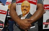 People hold posters of slain Saudi journalist Jamal Khashoggi, near the Saudi Arabia consulate in Istanbul, October 2, 2020, marking the two-year anniversary of his death (AP Photo/Emrah Gurel, File)