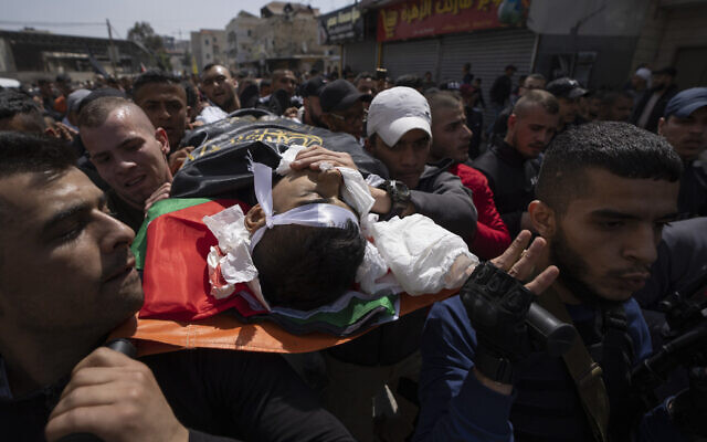 Palestinian mourners carry the body of Sanad Abu Atiyeh, 17 during his funeral in the West Bank refugee camp of Jenin, on March 31, 2022. (AP Photo/Nasser Nasser) Palestinian mourners carry the body of Sanad Abu Atiyeh, 17 during his funeral in the West Bank refugee camp of Jenin, on March 31, 2022. (AP Photo/Nasser Nasser)