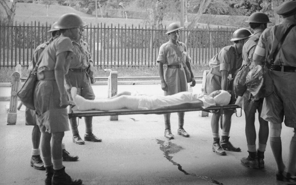 A British soldier, one of the casualties of the Malay Peninsula fighting, is brought into Singapore on February 9, 1942, for hospital care. (AP Photo/Frank Noel)
