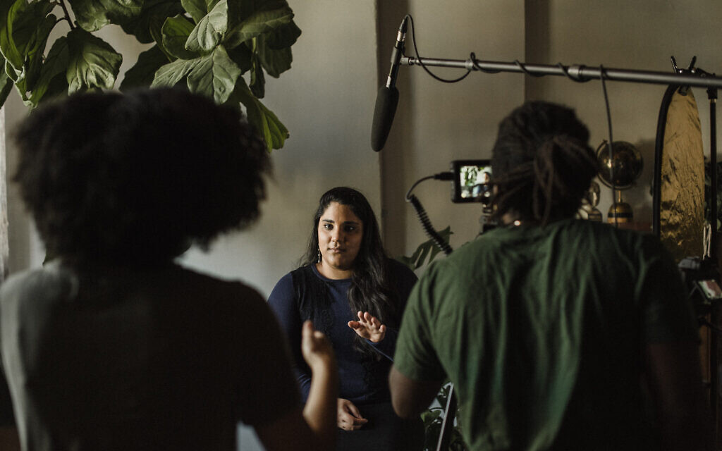Ariella Daniels  being interviewed during filming of 'Periphery,' part of the exhibition of the same name at UJA Toronto. (Liat Aharoni)