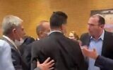 A scuffle between lawmakers in the Knesset plenum's back hallway, March 2, 2022. (screenshot)