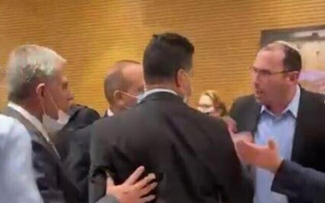 A scuffle between lawmakers in the Knesset plenum's back hallway, March 2, 2022. (screenshot) A scuffle between lawmakers in the Knesset plenum's back hallway, March 2, 2022. (screenshot)