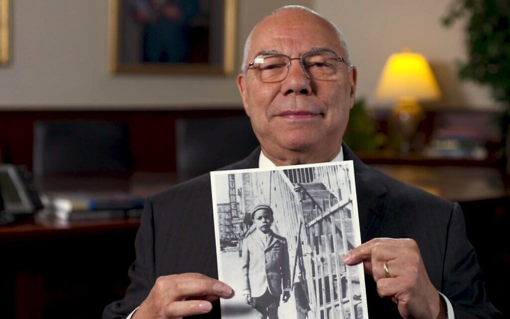 Colin Powell holding a photo of himself c. 1943 in 'The Automat.' (A Slice of Pie Productions)