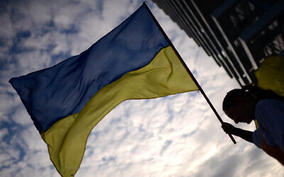 Illustrative -- Demonstrator at a protest march against the Russian invasion of Ukraine, in Tel Aviv, on February 26, 2022 (Tomer Neuberg/Flash90)