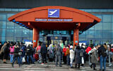 Ukrainians who fled fighting in Ukraine seen at the Chisinau International Airport in Moldova as they make their way to Israel, March 6, 2022. (Nati Shohat/Flash90)