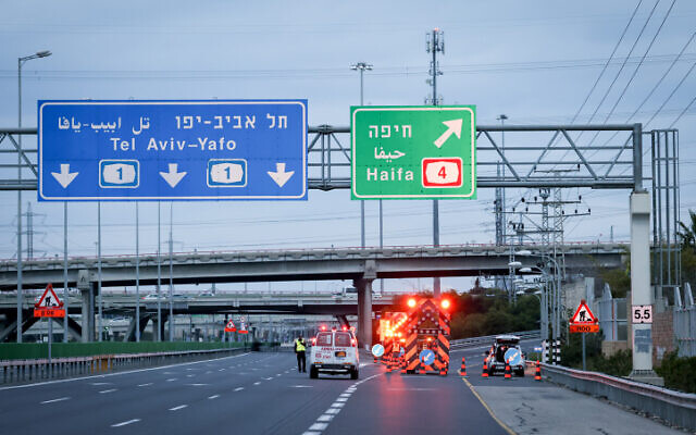Police erect temporary roadblocks off Route 1, near Route 4, ahead of the funeral of Rabbi Chaim Kanievsky, which is expected to draw hundreds of thousands in Bnei Brak, March 20, 2022. (Yonatan Sindel/FLASH90)