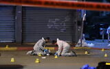 Members of the Zaka voluntary organization are seen at the scene of an attack in Hadera, March 27, 2022 (Gili Yaari/Flash90)