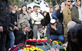 Mourners grieve at the grave of Israeli border police officer Shirel Aboukrat in Netanya on March 28, 2022. Aboukrat and colleague Yazan Falah were shot dead on March 27 in a terrorist attack in Hadera claimed by the Islamic State group in Hadera. (Shir Torem/Flash90)