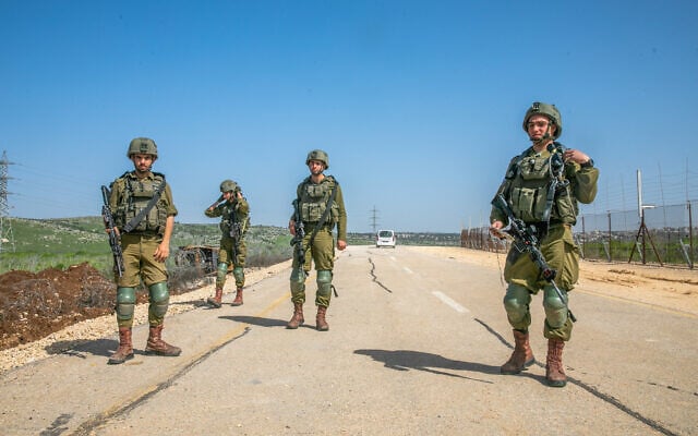 Illustrative: Israeli soldiers stand guard near a hole in the security fence, near the West Bank settlement of Mevo Horon, March 30, 2022. (Yossi Aloni/Flash90) Illustrative: Israeli soldiers stand guard near a hole in the security fence, near the West Bank settlement of Mevo Horon, March 30, 2022. (Yossi Aloni/Flash90)