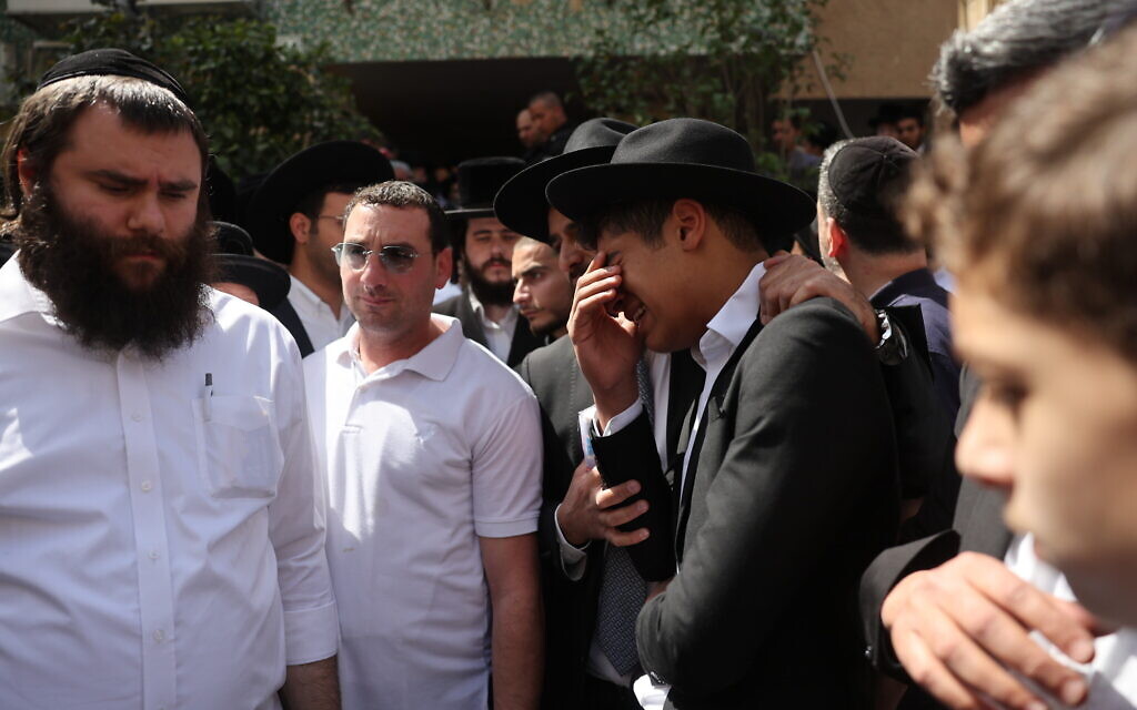 Mourners at the funeral of Ya'akov Shalom who was killed in a terror attack in Bnei Brak, March 30, 2022 (Yonatan Sindel/Flash90)