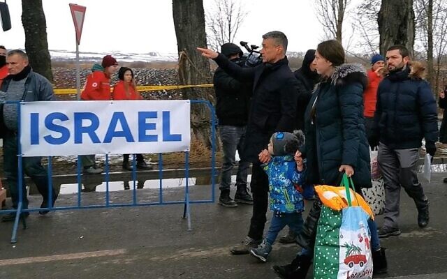 Israel's ambassador in Romania David Saranga (center) seen in the border town of Siret escorting sick Ukrainian children who will be airlifted to Israel to receive life-saving healthcare on March 8, 2022 (Courtesy)