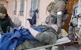 A Russian colonel is seen being evacuated after reportedly being run over by his own troops angered at huge losses suffered by the brigade while fighting in Ukraine. He was reported have later died (Screencapture/Twitter)