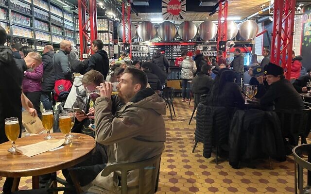 Saturday night in Pravda, a taproom that faces Lviv's city hall in Market Square, Lviv, Ukraine, March 19, 2022. (Carrie Keller-Lynn/The Times of Israel)