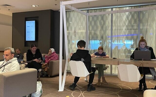 Ukrainian refugees in the lobby of Warsaw's Novotel Hotel, where the Jewish Agency has established a temporary headquarters, March 13, 2022. (Carrie Keller-Lynn/The Times of Israel) Ukrainian refugees in the lobby of Warsaw's Novotel Hotel, where the Jewish Agency has established a temporary headquarters, March 13, 2022. (Carrie Keller-Lynn/The Times of Israel)