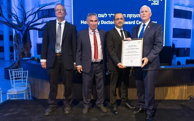 Mike Pence (R) is awarded an honorary doctorate at Ariel University in the West Bank, March 9, 2022. (Liron Modovan/Ariel University) Mike Pence (R) is awarded an honorary doctorate at Ariel University in the West Bank, March 9, 2022. (Liron Modovan/Ariel University)