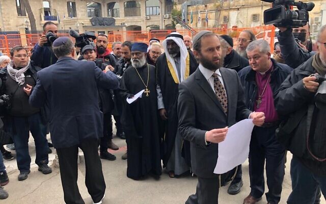 Rabbi Yonatan Neril posts an interfaith letter against the war in Ukraine to Russian Orthodox Patriarch Kirill on the walls of Jerusalem’s Holy Trinity Cathedral, March 21, 2022. (Lazar Berman/Times of Israel) Rabbi Yonatan Neril posts an interfaith letter against the war in Ukraine to Russian Orthodox Patriarch Kirill on the walls of Jerusalem’s Holy Trinity Cathedral, March 21, 2022. (Lazar Berman/Times of Israel)