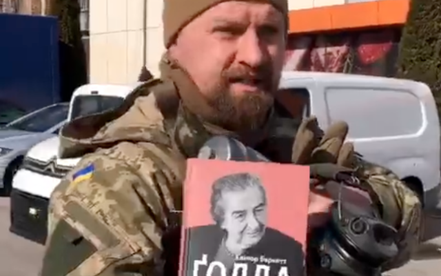 A Ukrainian soldier nicknamed Zion holds up a copy of a Golda Meir biography he carries with him into battle, on March 8, 2022. (Screenshot/Twitter) A Ukrainian soldier nicknamed Zion holds up a copy of a Golda Meir biography he carries with him into battle, on March 8, 2022. (Screenshot/Twitter)