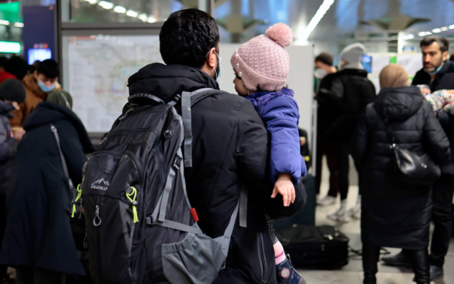 A man carries a child after refugees from Ukraine arrive at the main train station in Berlin, on March 1, 2022. (Hannibal Hanschke/Getty Images via JTA) A man carries a child after refugees from Ukraine arrive at the main train station in Berlin, on March 1, 2022. (Hannibal Hanschke/Getty Images via JTA)