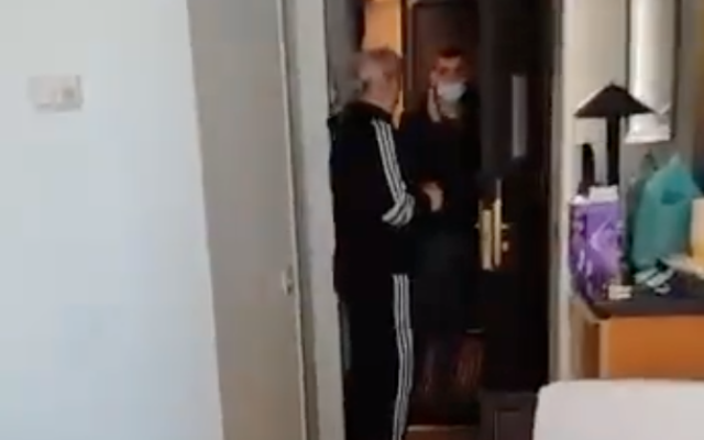 A Population Immigration and Border Authority official arrives at the hotel room of a Ukrainian refugee in Tel Aviv in order to deport her on March 14, 2022. (Screen capture/Twitter) A Population Immigration and Border Authority official arrives at the hotel room of a Ukrainian refugee in Tel Aviv in order to deport her on March 14, 2022. (Screen capture/Twitter)