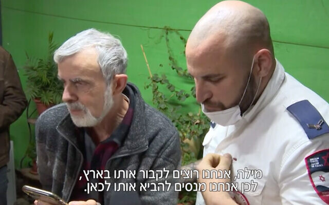 The father of Roman Brodsky, an Israeli killed in Ukraine, at left, discusses his burial arrangements during a phone call with his son's partner in Ukraine. A Magen David Adom paramedic, right, helped facilitate the call. (Screenshot/Channel 12) The father of Roman Brodsky, an Israeli killed in Ukraine, at left, discusses his burial arrangements during a phone call with his son's partner in Ukraine. A Magen David Adom paramedic, right, helped facilitate the call. (Screenshot/Channel 12)