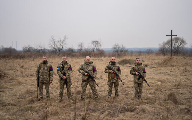 Ukrainian soldiers prepare to fire a salute during the funeral for their comrades, in Starychi, western Ukraine, March 16, 2022. (AP Photo/Bernat Armangue) Ukrainian soldiers prepare to fire a salute during the funeral for their comrades, in Starychi, western Ukraine, March 16, 2022. (AP Photo/Bernat Armangue)