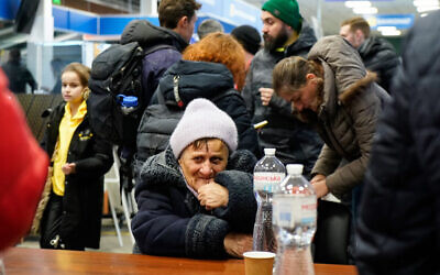 Evacuees from Mariupol at a shopping center on the outskirts of the city of Zaporizhzhia, which is now a registration centre for displaced people, on March 16, 2022. (Emre Caylak/AFP)