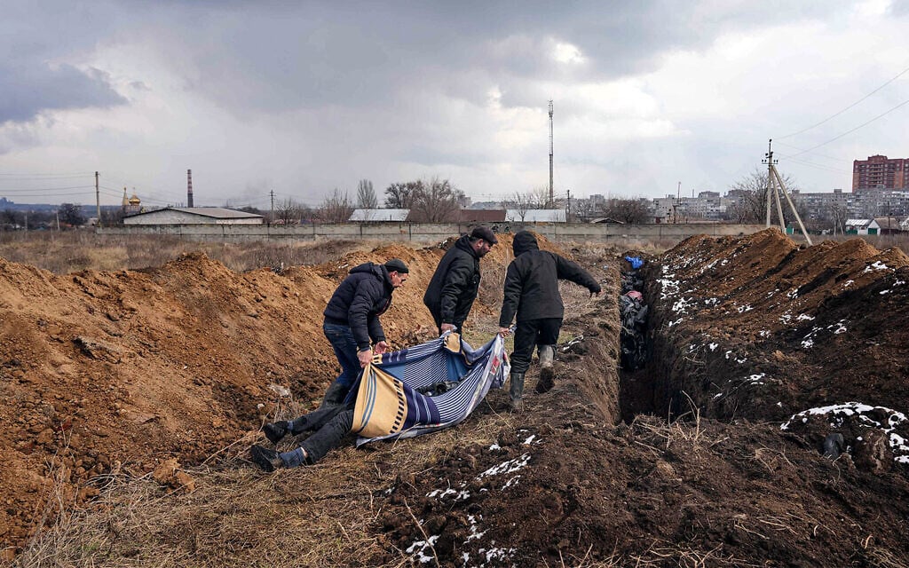 Dead bodies are put into a mass grave on the outskirts of Mariupol, Ukraine, March 9, 2022, as people cannot bury their loved ones because of the heavy shelling by Russian forces. (AP Photo/Evgeniy Maloletka) Dead bodies are put into a mass grave on the outskirts of Mariupol, Ukraine, March 9, 2022, as people cannot bury their loved ones because of the heavy shelling by Russian forces. (AP Photo/Evgeniy Maloletka)
