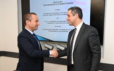 US DHS Under Secretary for Strategy, Policy and Plans Robert Silvers (right) signs a Memorandum of Understanding with Paul Landes, Head of the Defense Ministry's National Bureau for Counter Terror Financing in Tel Aviv, on March 1, 2022. (David Azagury/US Embassy Jerusalem)