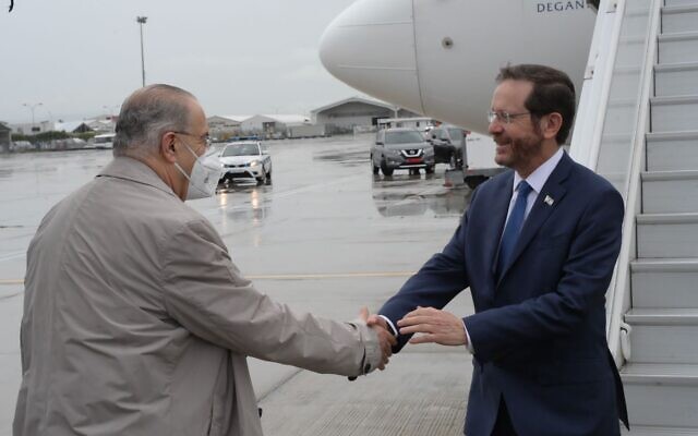 President Isaac Herzog is received at an
airport in Cyprus by Cypriot Minister of Foreign Affairs, Ioannis Kasoulides, March 2. 2022. (Amos Ben Gershom/GPO) President Isaac Herzog is received at an
airport in Cyprus by Cypriot Minister of Foreign Affairs, Ioannis Kasoulides, March 2. 2022. (Amos Ben Gershom/GPO)