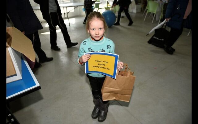 A child brought from Ukraine to Israel makes Purim parcels for other children in refugee camps on the Ukraine border (Courtesy/ Dennis Zinn) A child brought from Ukraine to Israel makes Purim parcels for other children in refugee camps on the Ukraine border (Courtesy/ Dennis Zinn)