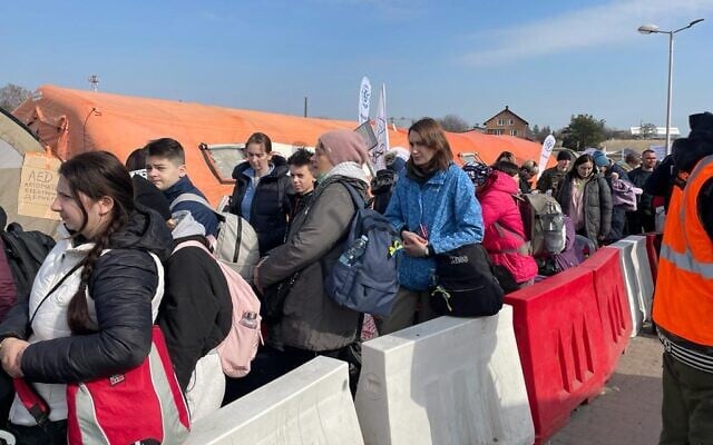 Ukrainian refugees at the border crossing between Poland and Ukraine, at Medyka, Poland, March 15, 2022. (Carrie Keller-Lynn/The Times of Israel)