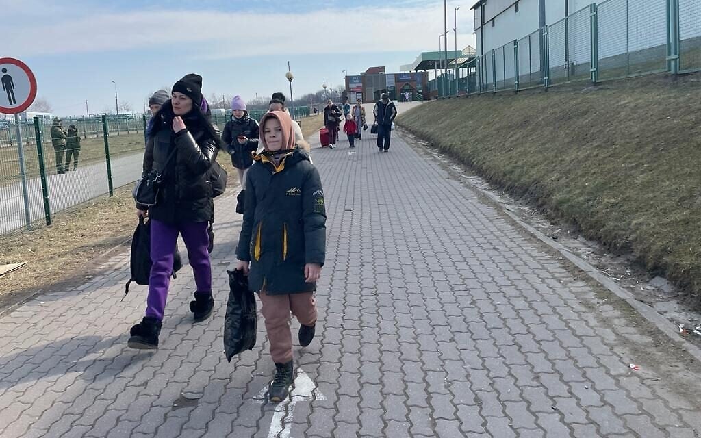 Illustrative: Ukrainian refugees arrive on Polish soil after crossing the border into Medyka, Poland, March 15, 2022. (Carrie Keller-Lynn/The Times of Israel)