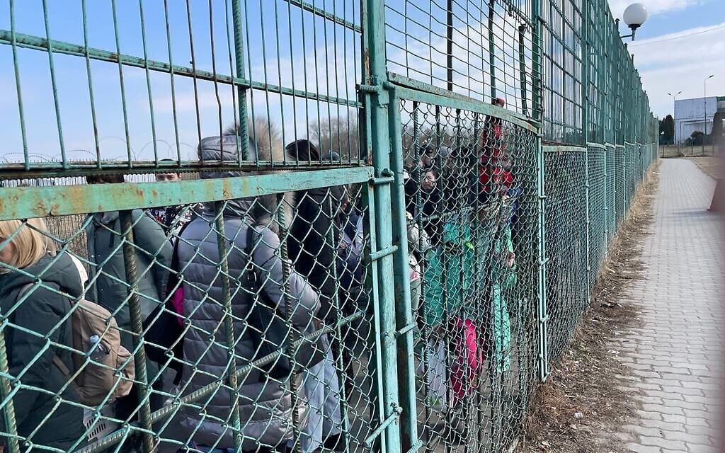 Ukrainian refugees in the space between border controls at the border crossing between Poland and Ukraine, at Medyka, Poland, and Shehyni, Ukraine, March 15, 2022. (Carrie Keller-Lynn/Times of Israel)
