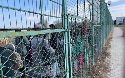 Ukrainian refugees in the space between border controls at the border crossing between Poland and Ukraine, at Medyka, Poland, and Shehyni, Ukraine, March 15, 2022. (Carrie Keller-Lynn/Times of Israel)