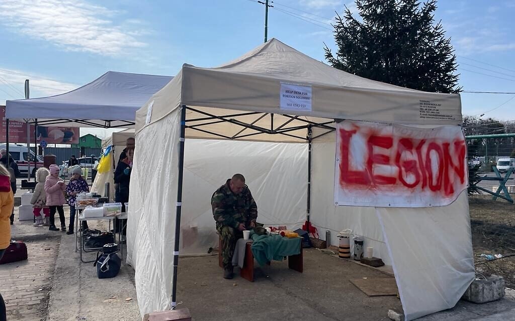 An Ukrainian army officer liaising with foreign military volunteers at the border crossing between Poland and Ukraine, at Shehyni, Ukraine, March 15, 2022. (Carrie Keller-Lynn/The Times of Israel)