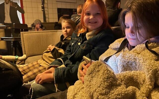 Varia Markarian, along with two friends and their mothers, shelter amid air rain sirens in the basement level of Pravda, a taproom that faces Lviv's city hall in popular Market Square, Lviv, Ukraine, March 19, 2022. (Carrie Keller-Lynn/The Times of Israel)