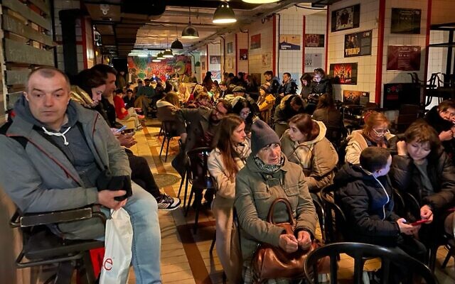 Hundreds shelter amid air rain sirens in the basement level of Pravda, a taproom that faces Lviv's city hall in popular Market Square, Lviv, Ukraine, on March 19, 2022. (Carrie Keller-Lynn/The Times of Israel)