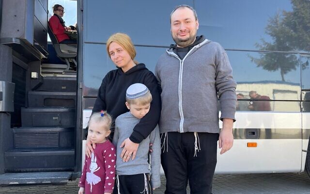 The Groisman family waits to re-board a Foreign Ministry-organized bus near Krakovets, Ukraine's border crossing to Poland, March 23, 2022. (Carrie Keller-Lynn/The Times of Israel)