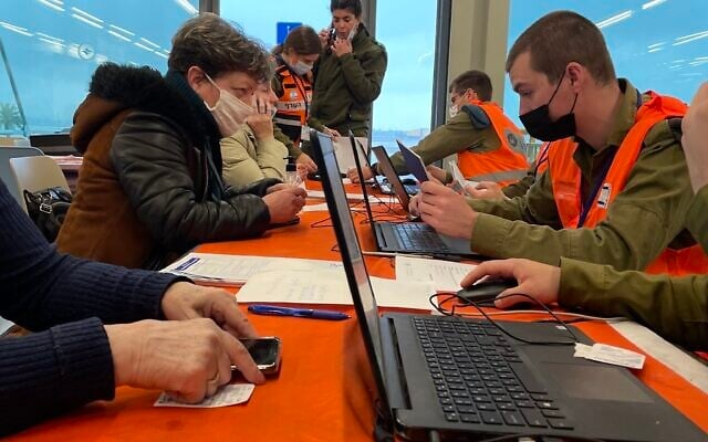 Soldiers from the Home Front Command record the passport details of Ukrainian newcomers at Terminal 1, Ben Gurion Airport, on March 18, 2022. (Sue Surkes/ Times of Israel) Soldiers from the Home Front Command record the passport details of Ukrainian newcomers at Terminal 1, Ben Gurion Airport, on March 18, 2022. (Sue Surkes/ Times of Israel)
