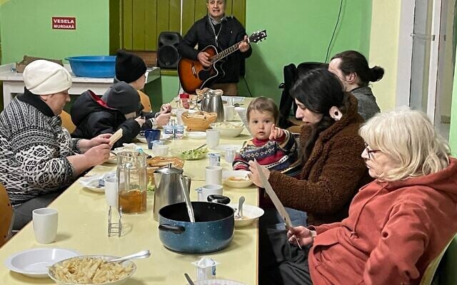 A Moldovan volunteer sings Hebrew songs to raise the spirits of Ukrainian refugees at a transit camp south of Kishinev on March 15, 2022. (Sue Surkes/Times of Israel) A Moldovan volunteer sings Hebrew songs to raise the spirits of Ukrainian refugees at a transit camp south of Kishinev on March 15, 2022. (Sue Surkes/Times of Israel)