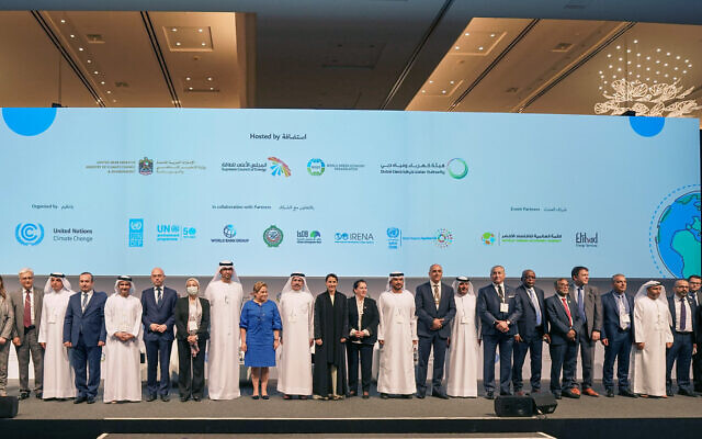 Patricia Espinosa, executive secretary of the United Nations Framework Convention on Climate Change (in blue), is flanked by dignitaries and environment ministers at the first Middle East and North Africa Climate Week in Dubai, United Arab Emirates, March 28, 2022. (Courtesy, UNFCCC) Patricia Espinosa, executive secretary of the United Nations Framework Convention on Climate Change (in blue), is flanked by dignitaries and environment ministers at the first Middle East and North Africa Climate Week in Dubai, United Arab Emirates, March 28, 2022. (Courtesy, UNFCCC)