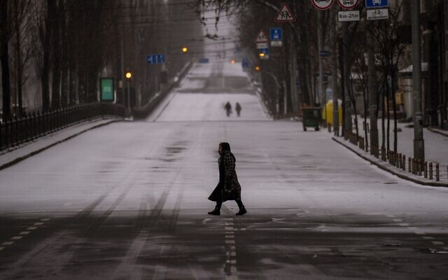 People walk along an empty road during curfew, in Kyiv, Ukraine, on Tuesday, March 1, 2022. (AP Photo/Emilio Morenatti) People walk along an empty road during curfew, in Kyiv, Ukraine, on Tuesday, March 1, 2022. (AP Photo/Emilio Morenatti)