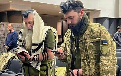 Jewish soldiers Asher, left, and David Cherkaskyi pray in their Dnipro, Ukraine, synagogue in 2022. (Courtesy David Cherkaskyi via JTA)