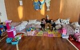 Ukrainian refugee children enjoy toys bought by Tami Jeffay and friends at the Kedem Jewish Community Center in Chisinau, Moldova, March 12, 2022. (courtesy)