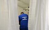 Illustrative: A medical worker treats a patient at the Israeli field hospital in Mostyska near the Polish border, western Ukraine, on March 23, 2022. (Yuriy Dyachyshyn/AFP)