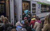 Refugees from Ukraine board a train en route to Warsaw at the railway station in Przemysl, southeastern Poland, near the Polish-Ukrainian border on April 1, 2022. (Angelos Tzortzinis/AFP)
